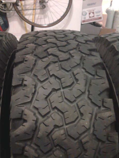 1983 Ferrari Enzo - Several off-road tires are lined up, showing their deep tread patterns.