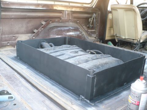 1979 Ford Bronco - Custom raised gas tank installation within the cargo area of a vehicle.