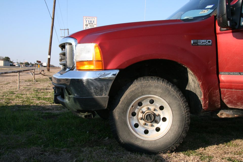 Red Ford F-350 Super Duty truck, front quarter view. F350 badge visible on fender