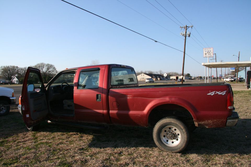 Red pickup truck with 4x4 decal, driver's door open
