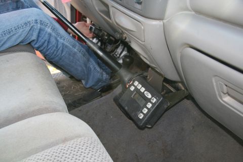 1993 Ford Bronco - A close-up shot of the interior of a vehicle, focusing on a control unit and a person's legs.