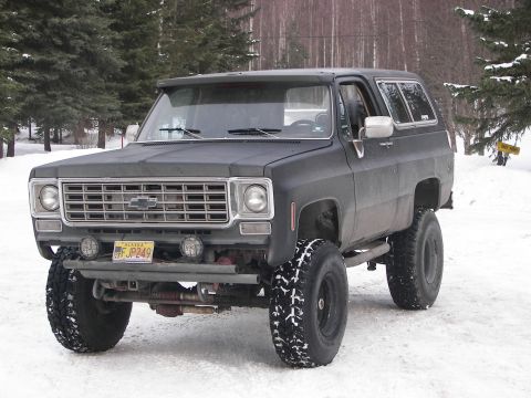 1990 Chevrolet Suburban - This lifted Chevrolet K5 Blazer is equipped with large off-road tires and parked in a snowy environment.