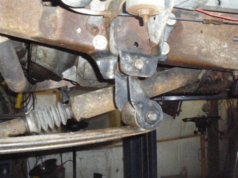 1994 Ford F-350 - This image shows a close-up view of a vehicle's rusty suspension components, including a spring mount and steering linkage.