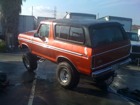 1978 Ford Bronco - This lifted 1978 Ford Bronco is shown from a rear-three-quarter angle under a bright sky.