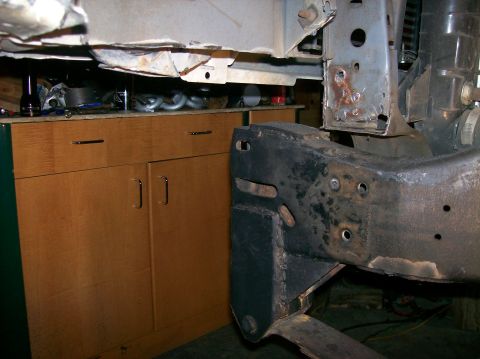 1989 Ford Bronco - Vehicle frame and suspension parts are visible, with a cabinet in the background.