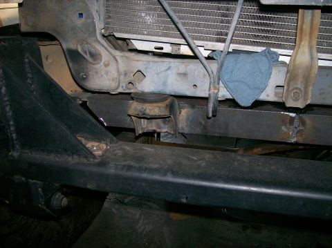 1989 Ford Bronco - Close-up view of the front bumper and radiator support structure of a vehicle.