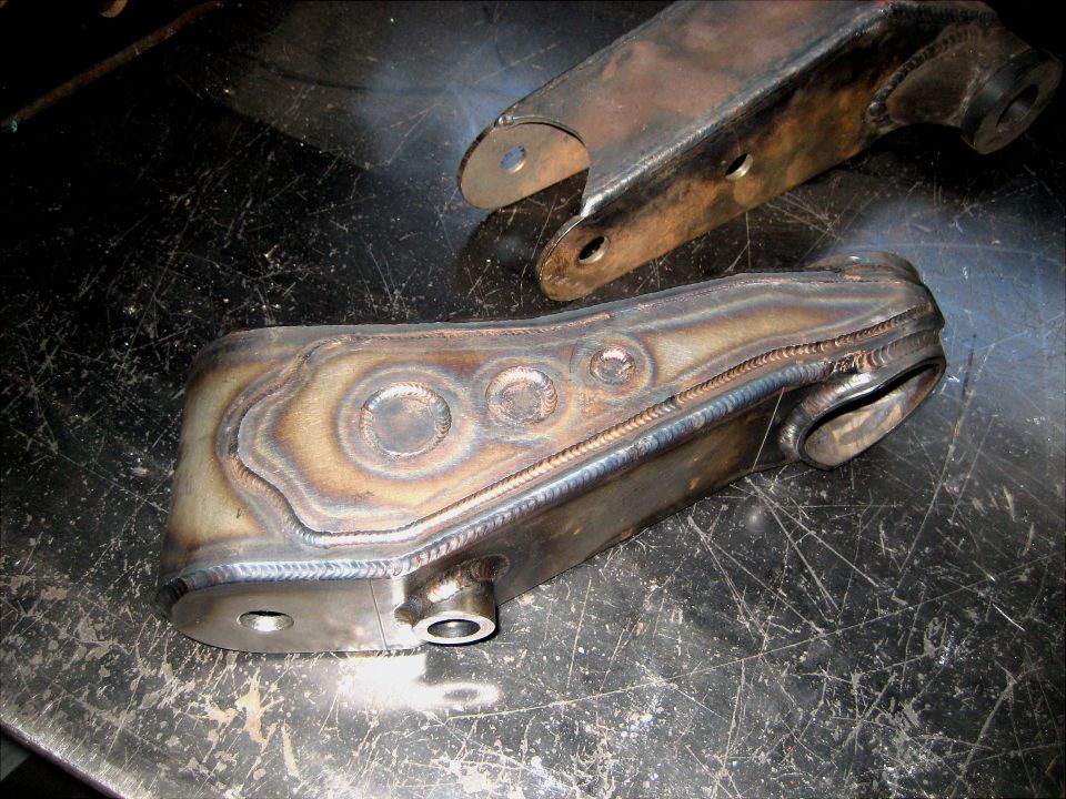 Welded metal steering component with circular indentations and visible weld lines