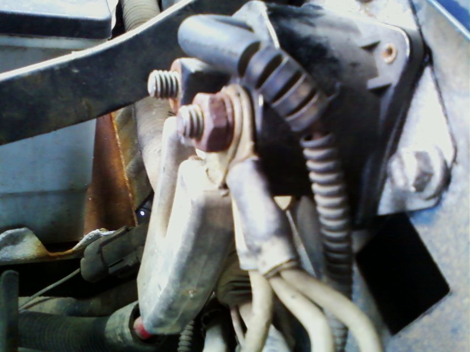 Close-up of starter motor wiring with bolts and electrical connectors