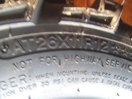 1996 Ford Bronco - Close-up of a tire sidewall showing size information and a warning that it is not for highway use.