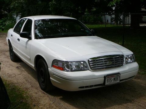 2003 Ford Crown Victoria - This 2003 Ford Crown Victoria is seen from a three-quarter front view, its distinctive chrome grille and a Wisconsin license plate.