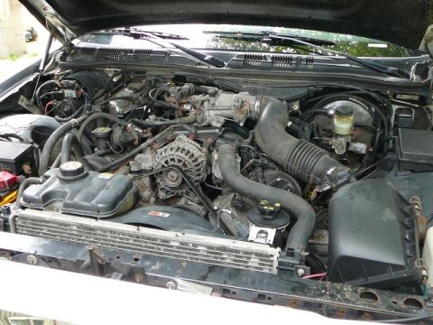 2003 Ford Crown Victoria - Engine bay of a 2003 Ford Crown Victoria, showing the radiator and air intake system.