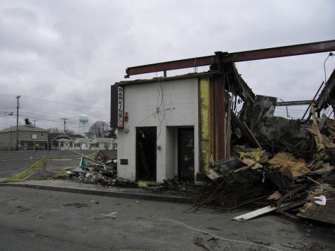 2001 Ford Crown Victoria - Scene of a destroyed building with rubble and a visible 'PARKING' sign.