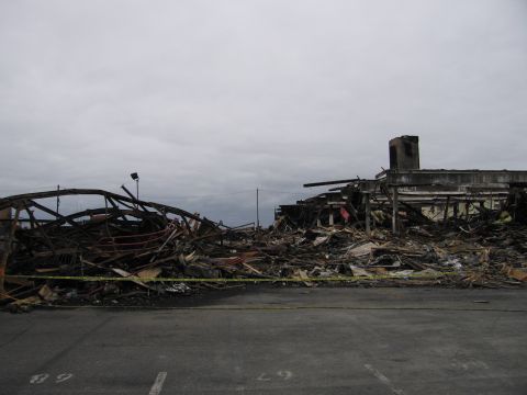 2001 Ford Crown Victoria - Scene of a building destroyed by fire, showing extensive structural damage and debris.