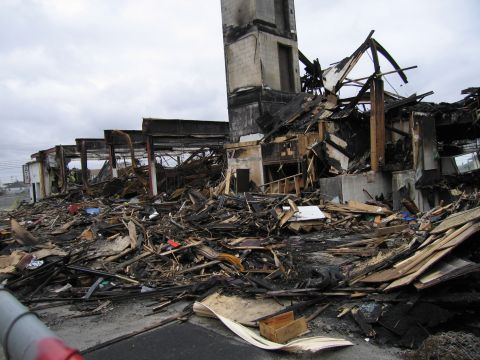 2001 Ford Crown Victoria - The scene shows the extensive damage and debris left behind after a fire.