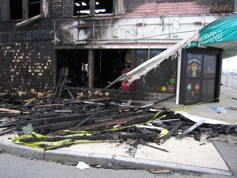 2001 Ford Crown Victoria - The scene shows the extensive damage to a building and its surroundings following a fire.