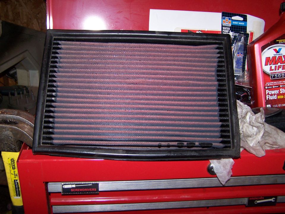 Red air filter with black frame on red toolbox