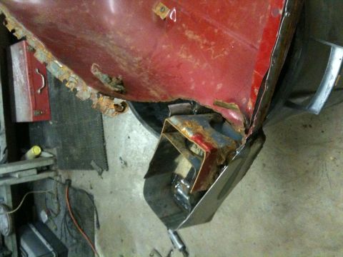 1993 Ford Bronco - Close-up of a heavily rusted vehicle body panel, showing significant corrosion and structural damage.