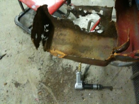 1993 Ford Bronco - A heavily rusted vehicle panel is shown with an air tool nearby, suggesting repair work.