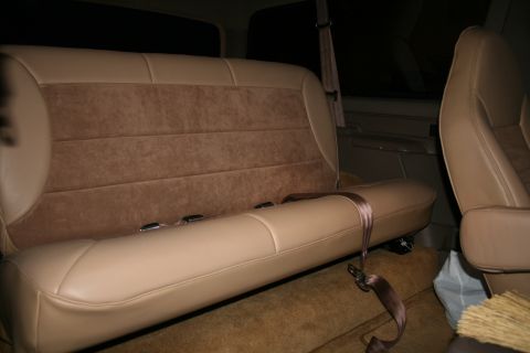 1995 Ford Bronco - Vehicle interior showing rear bench seat and part of a front seat.