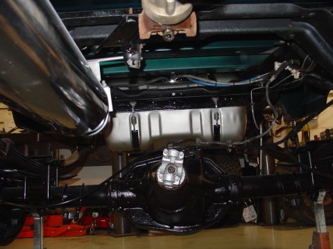 1995 Ford Bronco - The rear axle and suspension components of a truck are visible from underneath, suggesting maintenance or repair work.
