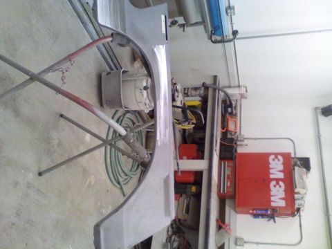 1979 Ford F-250 - A car fender is prepped in a workshop environment, with various tools and supplies nearby.