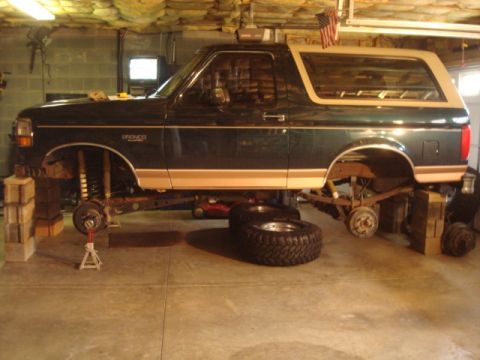 1995 Ford Bronco - Bronco on blocks ready to pull stock front and rear axles out.