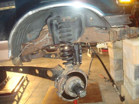 1995 Ford Bronco - Front suspension and brake assembly of a 1995 Ford Bronco undergoing tear down.