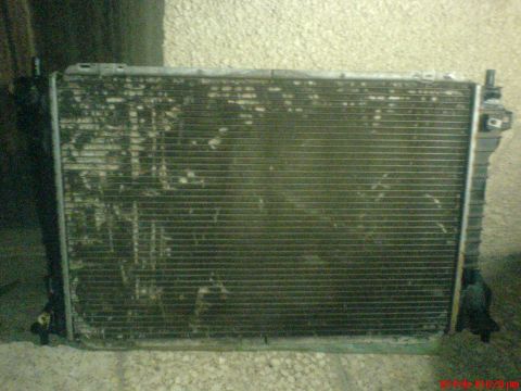 1998 Ford Crown Victoria - A radiator, likely for a vehicle, shows signs of wear and corrosion. The Supermotors.net logo is visible in the lower right corner.