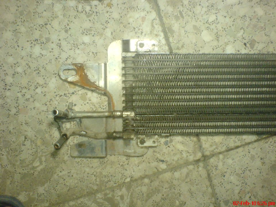 transmission cooler with rusty bracket and metal lines