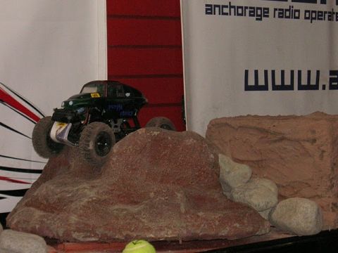 1993 Suzuki Sidekick - A toy remote control car navigates a rocky terrain.