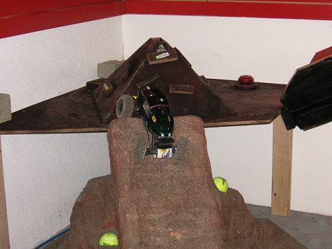 1993 Suzuki Sidekick - A remote-controlled rock crawler navigates a challenging obstacle course, complete with artificial rocks and tennis balls.