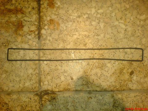 1998 Ford Crown Victoria - A rectangular gasket is shown lying on a speckled tiled floor, with a watermark from Supermotors.net visible in the lower right corner.