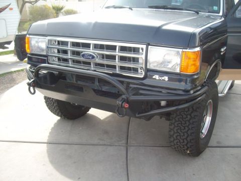 1993 Ford Bronco - Ford F-Series truck front end, likely early 1990s model, with custom bumper and 4x4 badging.