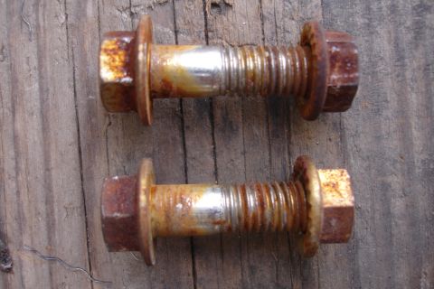1995 Ford Taurus - These two bolts are heavily rusted and show signs of wear on their threaded sections.
