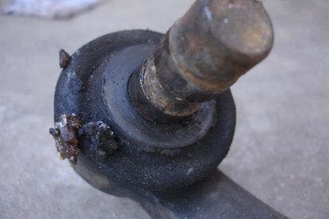 1995 Ford Taurus - A close-up view of a used automotive suspension component, showing signs of wear and tear.