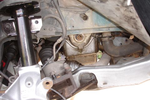 1995 Ford Taurus - Close-up view of the engine oil pan and suspension components, likely during maintenance or repair.