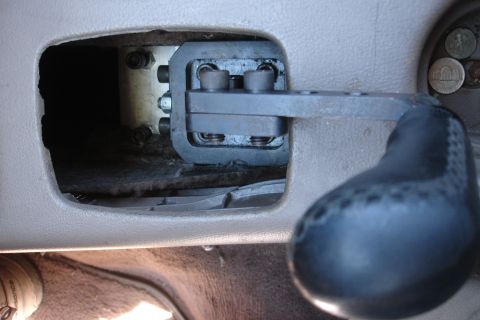 1995 Ford Taurus - The interior of a car reveals a custom short shifter mechanism, suggesting modifications to the gear selection system.
