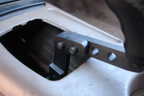 1995 Ford Taurus - Close-up of a short shifter mechanism installed in a vehicle's center console.