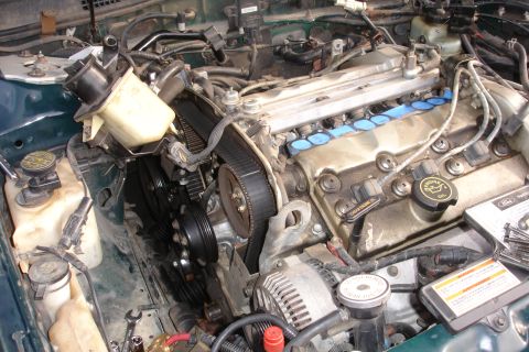 1995 Ford Taurus - Close-up view of a disassembled engine bay, showing internal components and wiring.