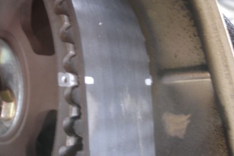 1995 Ford Taurus - A close-up view of a vehicle's timing belt and pulley system, showing alignment marks on the belt.