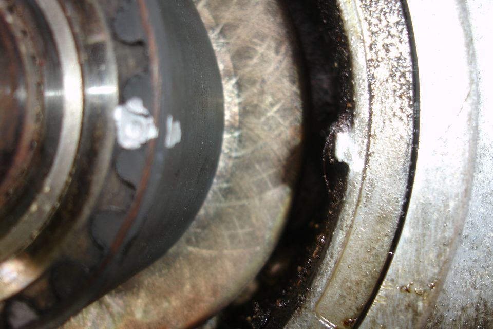 Close-up of a cam seal and bearing with some white residue