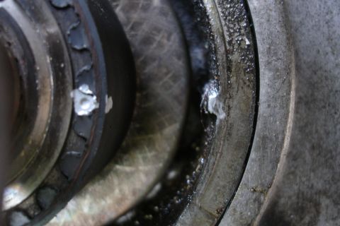 1995 Ford Taurus - This close-up shows damage to an engine component, with visible metal fragments and accumulated dirt.