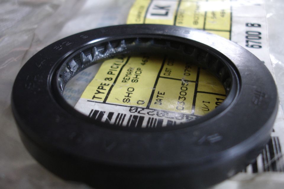 close-up of an oil seal with a yellow label underneath