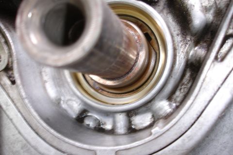 1995 Ford Taurus - A detailed view of an engine component, focusing on a metal shaft and its surrounding seals.