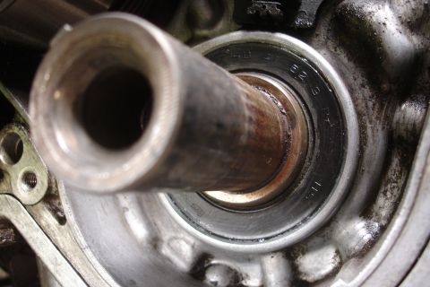 1995 Ford Taurus - A close-up view of a worn engine bearing, showing some visible part numbers.