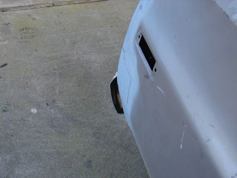 1973 Ford Ranchero - The rear of a vehicle is shown, prepped for paint, with an exhaust pipe visible.