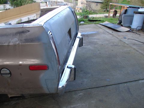 1973 Ford Ranchero - The rear of a 1973 Ford Ranchero shows its chrome bumper and taillight, with the truck bed visible above.