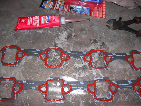 1991 Ford Bronco - Engine gaskets prepared with RTV sealant, alongside automotive repair supplies.