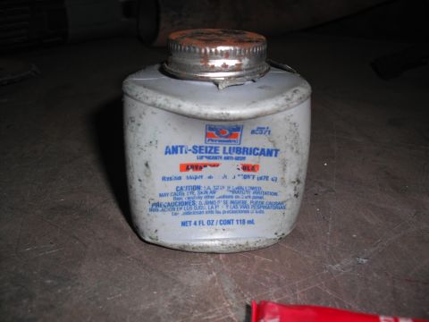 1991 Ford Bronco - A bottle of anti-seize lubricant is shown with a rusty cap and some dirt on its exterior.