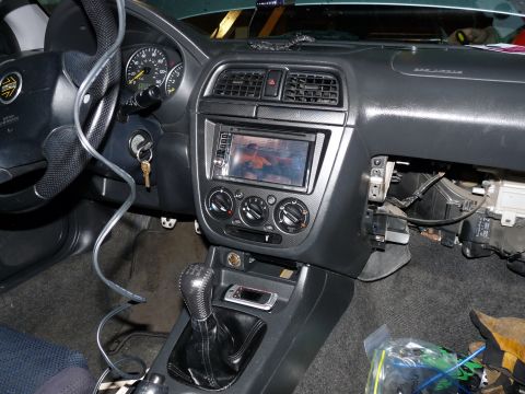 2006 Ford E350 - The interior of a car shows the dashboard, steering wheel, and center console with an aftermarket stereo installed.